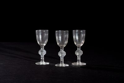three empty wine glasses sitting on a black surface