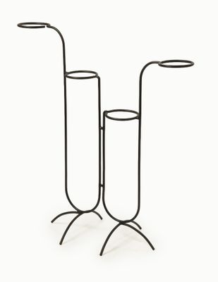 pair of black metal candlesticks on stand on a white background