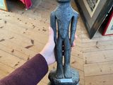 a person that is holding a statue in their hand