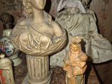 a statue of a woman and a statue of a man on a table