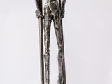 a statue of a man holding a pole on a white background