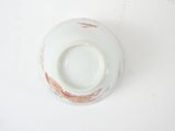 a white bowl with a brown rim on a white table