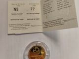a close up of a gold coin on a table with a receipt