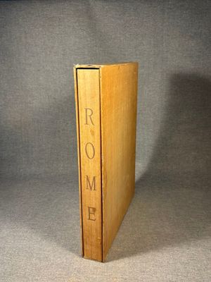 a book that is sitting on a table in front of a gray background