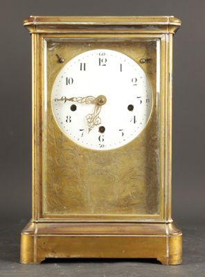 a gold clock that is sitting on a table