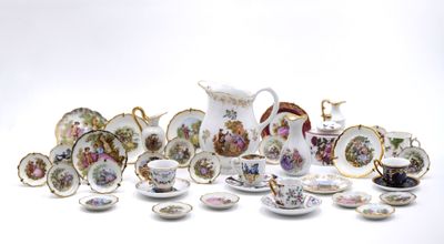 many different types of porcelain dishes and cups on the table