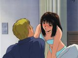 scène d'anime montrant un homme et une femme au lit, la femme se caressant la tête