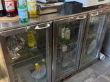 many bottles of alcohol on the counter in the kitchen