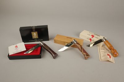une boîte contenant un couteau, un aiguiseur de couteaux et une boîte remplie d'argent