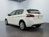 the rear end of a white car parked in a garage