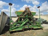 a large green machine that is sitting in the dirt