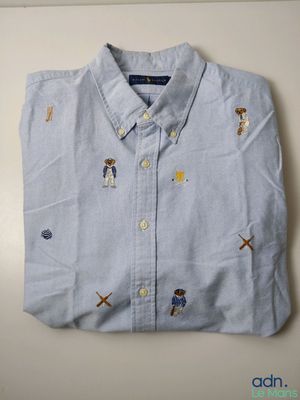 a close up of a shirt with a dog on it on a table