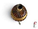 a small brass object on a white surface