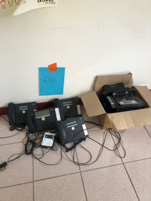 many phones that are sitting in a box on the floor