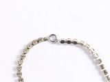 silver and black beaded bracelet on white background with silver beads