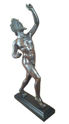 bronze statue of a man holding a tennis racket on a marble base