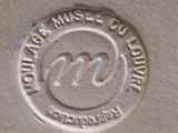a close up of a silver plate with a logo on it