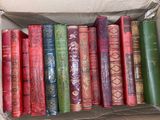 a box full of old books sitting on top of a table