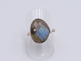 a close up of a ring with a labradorite stone in it