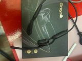a box with a pair of headphones and a pen on a table