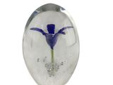 a glass object with a flower inside of it