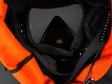 an overhead view of an orange bag with a cell phone in it