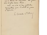 un livre ouvert sur lequel figure une note manuscrite