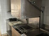 a kitchen with a sink, stove, and oven in it