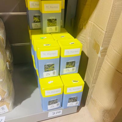 many boxes that are sitting on a shelf in a room