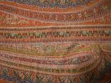 an image of a close up of a colorful shawl on a table