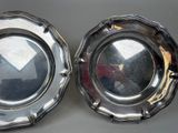 pair of silver plated dishes on a table with a mirror in the middle