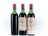 three bottles of red wine sitting next to each other on a white surface
