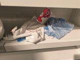 a stuffed animal that is sitting on a shelf in a closet