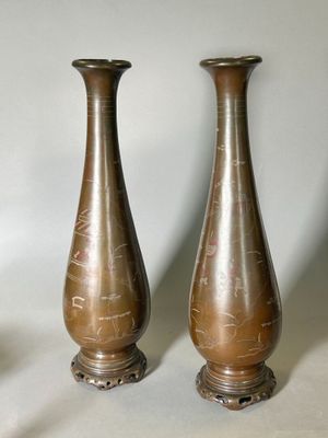 two vases sitting next to each other on a table