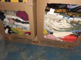 a cardboard box filled with clothes and a pair of scissors