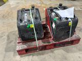 two suitcases sitting on a pallet in a warehouse
