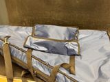 a suitcase with a bag on top of it sitting on a table