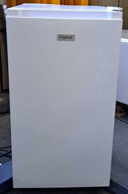 a white refrigerator that is sitting on the ground