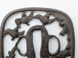a metal object that has a bird and a bird on it