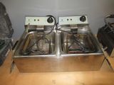 two deep fryers that are sitting on a table