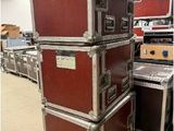 many suitcases stacked on top of each other in a warehouse