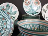 many plates and bowls that are sitting on a table
