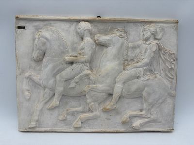 marble relief of a man riding a horse and a woman on a horse
