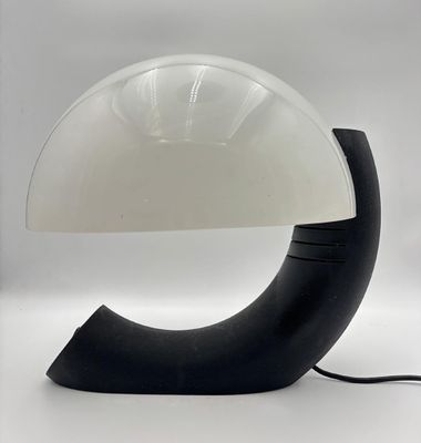 a black and white lamp that is on a table