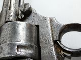 a close up of a gun on a white surface