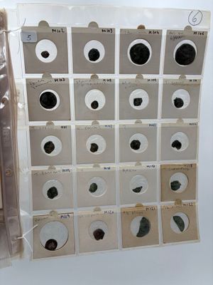 a picture of a collection of old papers and coins