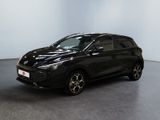 Une voiture noire est garée dans une pièce aux murs blancs.