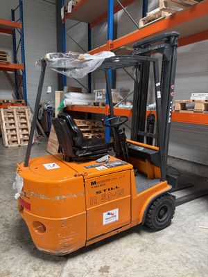 a forklift truck that is parked in a warehouse