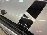 a close up of a car with a black and white stripe on it