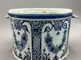 an image of a blue and white planter with floral designs on it